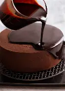 <p>Applying a shiny sauce, frosting, or icing to the surface of food. </p><p>This can also be done by coating food with a melted substance, i.e. sugar.</p>