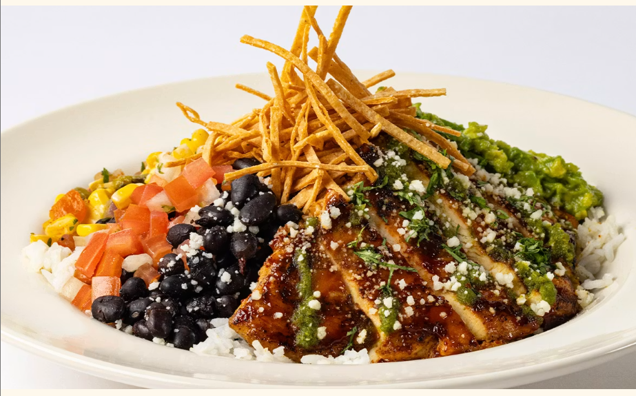 <p>Grilled Chicken with Rice, Beans, Roasted Corn Salsa, Guacamole, Sour Cream and Crispy Tortilla Strips</p>