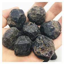 <ul><li><p>Commonly dark red and reddish brown</p></li><li><p>Crystals are rounded with diamond shaped faces</p></li></ul><p></p>