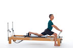 <p><strong>Setup</strong></p><ul><li><p>Standing, front leg bent in line with footbar, knee over ankle, knee of other leg placed on carriage, foot against shoulder rest, arms straight, hands placed on footbar, thumbs together with fingers (applies to all exercises), inside hand in line with shoulder</p></li><li><p>Resistance: light | <strong>Springs:&nbsp;1R</strong></p></li></ul><p><strong>Movement</strong></p><ul><li><p>Inhale: Stretch hip flexors of leg on carriage (3-5 breaths)</p></li><li><p>Exhale: Dorsiflex foot on floor, straighten leg and lower trunk forward (3-5 breathes)</p></li><li><p>Inhale: Bend front leg, return to start position</p></li><li><p>Change sides after 2 repetitions</p></li></ul><p><strong>Muscle Focus</strong></p><ul><li><p>Hip flexors</p></li><li><p>Hip extensors</p></li></ul><p><strong>Objectives</strong></p><ul><li><p>Hip flexor stretch</p></li><li><p>Hip extensor stretch</p></li></ul><p><strong>Cues</strong></p><ul><li><p>Bias toward posterior tilt of pelvis during hip flexor stretch</p></li><li><p>Bias toward anterior tilt of pelvis during hamstring stretch</p></li><li><p>Move pelvis along horizontal line when straightening and bending front leg</p></li></ul><p></p>