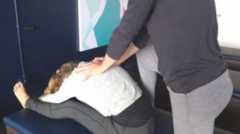 <p>Instructions</p><p>Stand on the ground at the end of the bench behind the client.</p><p>Move the client to the end of the bench (facing away from you) and have them sit on the bench with both legs straight out in front and feet about shoulder width apart.</p><p>Make sure client's feet are pointing upward, not falling to the side.</p><p>If the client struggles to get into forward flexion, have the client bend their knees slightly (upward, not out to the side).</p><p>Start the stretch by having the client move their chin towards their chest and then slump forward letting their head and shoulders fall towards their knees (ALWAYS TUCK CHIN FIRST).</p><p>Move one foot in front of the other for stability and leverage, and place your hands on the client's shoulder blades.</p><p>Activate your core, keep your back straight and lockout your arms.</p><p>Using your body weight, lean forward and gently apply forward and downward pressure, pushing the</p><p>client's chest towards their knees and feet.</p>