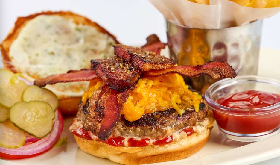 <p>Charbroiled and Covered with Melted Cheddar and American Cheese, Crispy Bacon, Thick-Cut Slow Roasted Smoked Bacon, Secret Sauce, Lettuce, Tomato and Onion</p>