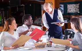 <p>The customer is studying the menu.</p>