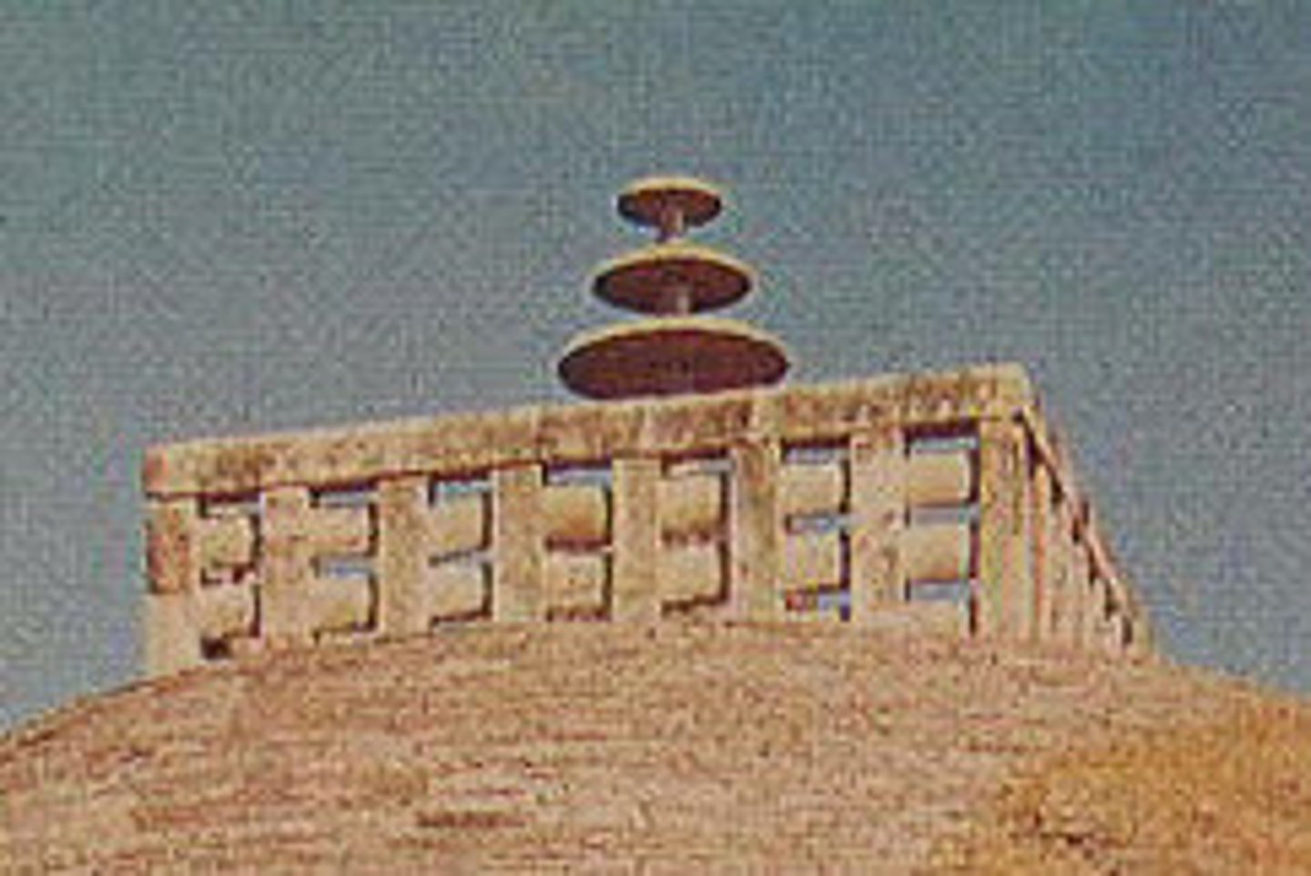 <p>parasol forms on the top of stupas, symbolizing the three heavens, the Three Jewels, and the rule of the Buddha over the cosmos</p>