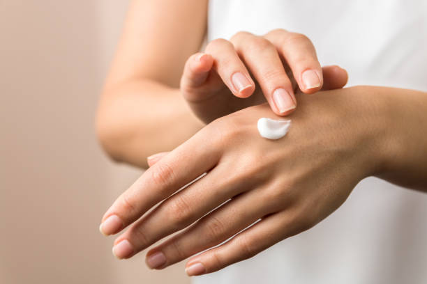 <p>The woman is putting _________ on her hands.</p>