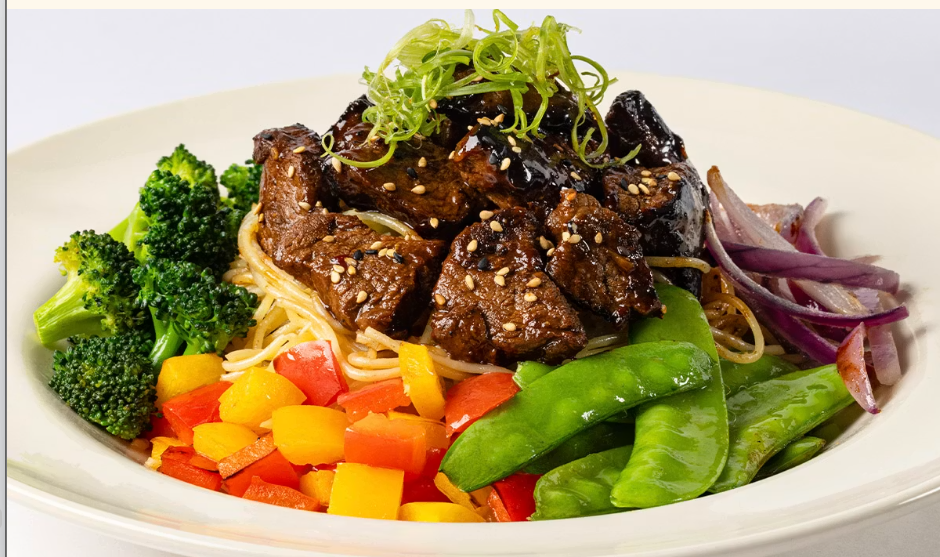 <p>Tender Pieces of Steak with Snow Peas, Broccoli, Peppers, Onion and Sesame. Served Over Garlic Noodles</p>