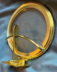 <p>thin, circular receptable with a glass face that holds the consecrated Host used for Adoration and Benediction, slides into monstrance on a track</p>