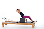 <p><strong>Setup</strong></p><ul><li><p>Starting in Round Back position (page 30), extend spine, hands interlaced behind head</p></li><li><p>Resistance:<strong> all springs attached to hold carriage in place</strong></p></li></ul><p><strong>Movement</strong></p><ul><li><p>Inhale: Hinge trunk back</p></li><li><p>Exhale: Hinge trunk forward, return to start posistion</p></li></ul><p><strong>Muscle Focus</strong></p><ul><li><p>Spinal flexors</p></li><li><p>Spinal extensors</p></li><li><p>Hip flexors</p></li></ul><p><strong>Objectives</strong></p><ul><li><p>Spinal flexor strength</p></li><li><p>Spinal extensor control</p></li><li><p>Hip flexor strength</p></li><li><p>Trunk stabilization</p></li></ul><p><strong>Cues</strong></p><ul><li><p>Avoid thrusting ribs forward</p></li><li><p>Keep head aligned with spine</p></li><li><p>Touch fingers loosely behind head</p></li><li><p>Maintain co-contraction of abdominals and back extensors</p></li><li><p>Move around hip joint</p></li></ul><p></p>