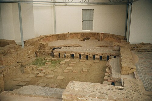 <p>a semicircular recess with stone benches, used as a place for discussion</p>