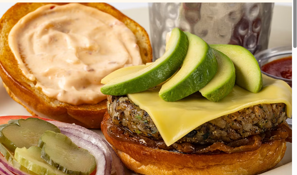 <p>Our Housemade Veggie “Burger” with Brown Rice, Farro, Mushrooms, Black Beans, Avocado, Lettuce, Tomato, Onion, Pickles and Cheese. Served with Our Special Sauce on a Toasted Brioche Bun</p>