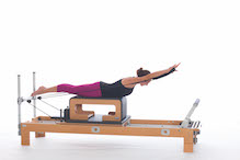 <p><strong>Setup</strong></p><ul><li><p>Start in Breaststroke Prep 1 position (page 80), elbows bent by sides of body, thumbs in straps, hands in line with shoulders</p></li><li><p>Resistance: light | <strong>Springs: 1B or 1R</strong></p></li></ul><p><strong>Movement</strong></p><ul><li><p>Inhale: Lift trunk, straighten arms forward, circle arms around to sides of body</p></li><li><p>Exhale: Bend arms, lower trunk, return to start position</p></li></ul><p><strong>Muscle Focus</strong></p><ul><li><p>Spinal extensors</p></li><li><p>Hip extensors</p></li><li><p>Elbow extensors</p></li><li><p>Shoulder abductors</p></li></ul><p><strong>Objectives</strong></p><ul><li><p>Spinal extensor strength</p></li><li><p>Elbow extensor control</p></li><li><p>Shoulder abductor control</p></li></ul><p><strong>Cues</strong></p><ul><li><p>Keep legs parallel to floor</p></li><li><p>Initiate movement with back extensors</p></li><li><p>Maintain external rotation of shoulders as body is lowered and elbows bend during final phase of movement</p></li></ul><p></p>