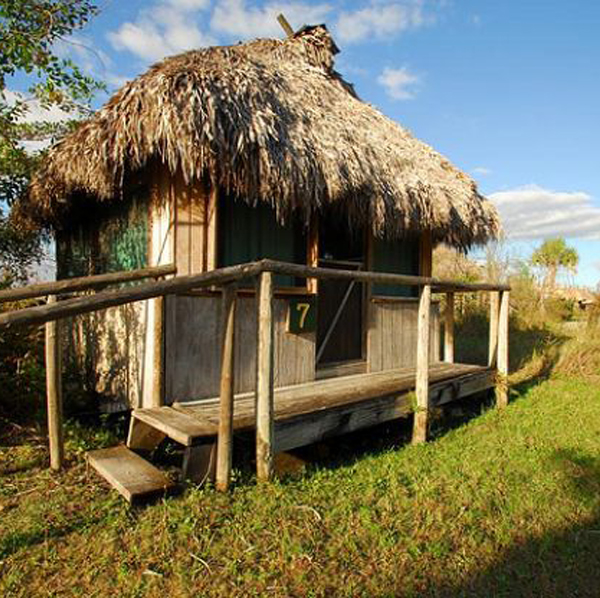 <p>Raised on posts with open sides and a thatched roof to provide airflow, shade, and protection from flooding in a hot, humid climate.</p>