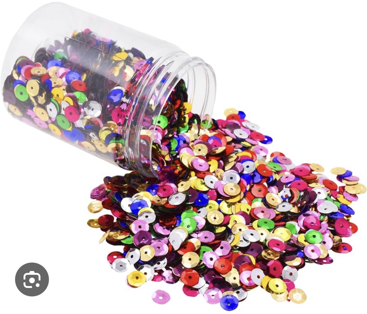 <p>A small, shiny metal or plastic. (Lentejuela)</p>