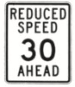 <p>This is a “reduced speed <em>ahead</em>” sign. You as a driver should know:</p>