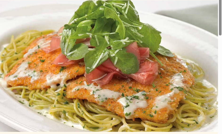 <p>Crispy Coated Chicken Breast over Basil Pasta and Parmesan Cream Sauce Topped with Prosciutto and Arugula Salad</p>