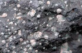 <p>Vesicles filled entirely with secondary minerals such as quartz, calcite, or zeolites. </p>