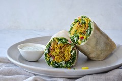 <p>Crispy golden falafel, pickled, red onions, hummus, kale and brussels sprout slaw, pepperoncini, and herby aioli, served in a grain-free tortilla wrap.</p><p>Sauce options: Greek goddess (rec), Hummus, Herby Aioli, Non-dairy Ranch dressing. No side sauce. </p><p>Extra sauce +$1.95</p><p>Modifications: none</p><p>Allergens: soy, sesame</p>