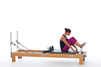 <p><strong>Setup</strong></p><ul><li><p>Sitting on carriage, legs bent, toes placed on footbar, feet in V position, hands placed on front edge of carriage, trunk in C curve position</p></li><li><p>Resistance: medium | <strong>Springs: 2R or 2R + 1B</strong></p></li></ul><p><strong>Movement</strong></p><ul><li><p>Exhale: Straighten legs, dorsiflex feet, plantarflex feet</p></li><li><p>Inhale: Bend legs, return to start position</p></li></ul><p><strong>Muscle Focus</strong></p><ul><li><p>Spinal flexors</p></li><li><p>Spinal extensors</p></li><li><p>Knee extensors</p></li><li><p>Ankle-foot plantarflexors</p></li></ul><p><strong>Objectives</strong></p><ul><li><p>Pelvic lumbar stabilization</p></li><li><p>Knee extensor control</p></li><li><p>Ankle-foot plantarflexor strength</p></li></ul><p><strong>Cues</strong></p><ul><li><p>Maintain C curve position</p></li><li><p>Keep shoulders aligned over hips</p></li><li><p>Press hands against front of carriage</p></li><li><p>Straighten legs completely prior to dorsiflexion and plantarflexion</p></li></ul><p></p>