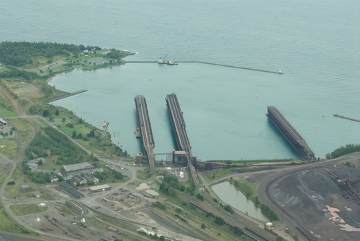<p>A sheltered area of water where ships can safely anchor or dock.</p>