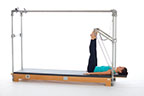<p><strong>Setup</strong></p><ul><li><p>Lying supine, legs externally rotated, toes placed on outer edge of PTBar, wide V position, legs bent</p></li><li><p>Resistance: medium to heavy <strong>[bottom loaded] 2 springs + safety belt</strong></p></li></ul><p><strong>Movement</strong></p><ul><li><p>Exhale: Straighten legs</p></li><li><p>Inhale: Bend legs, return to start position</p></li></ul><p><strong>Muscle Focus</strong></p><ul><li><p>Hip extensors</p></li><li><p>Knee extensors</p></li></ul><p><strong>Objectives</strong></p><ul><li><p>Hip extensor strength</p></li><li><p>Knee extensor control</p></li><li><p>Foot alignment and stabilization</p></li><li><p>Hip adductor control</p></li><li><p>Pelvic lumbar stabilization</p></li></ul><p><strong>Cues</strong></p><ul><li><p>Establish maximum plantarflexion when legs are straight</p></li><li><p>Keep heels stable, moving around ankle joint</p></li><li><p>Maintain hip extensor engagement</p></li><li><p>Maintain pelvic lumbar stabilization</p></li><li><p>Avoid excessive knee flexion (maximum 90 degrees)</p></li><li><p>Straighten legs completely, avoiding hyperextension</p></li></ul><p></p>