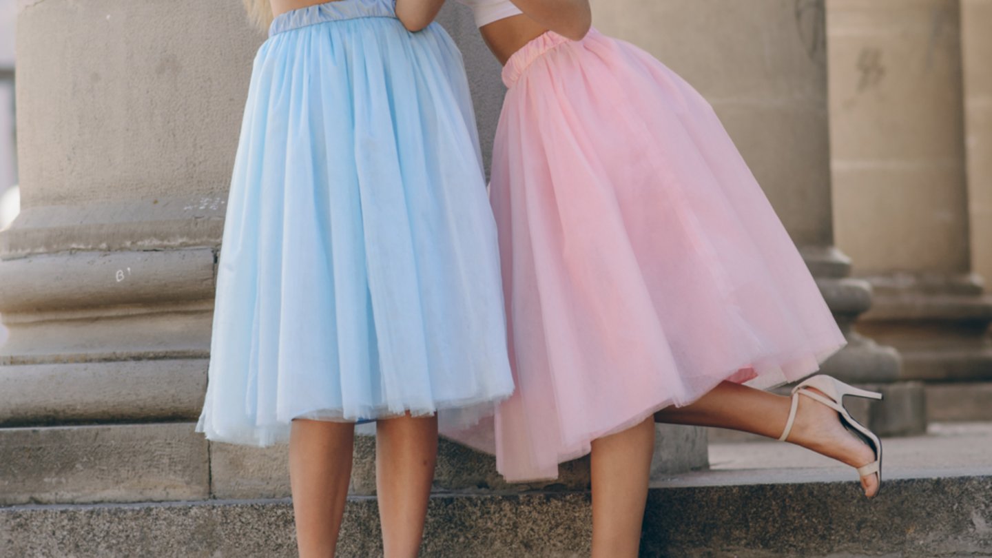 <p>an item of clothing hanging down around the legs, worn typically by women and girls.</p>
