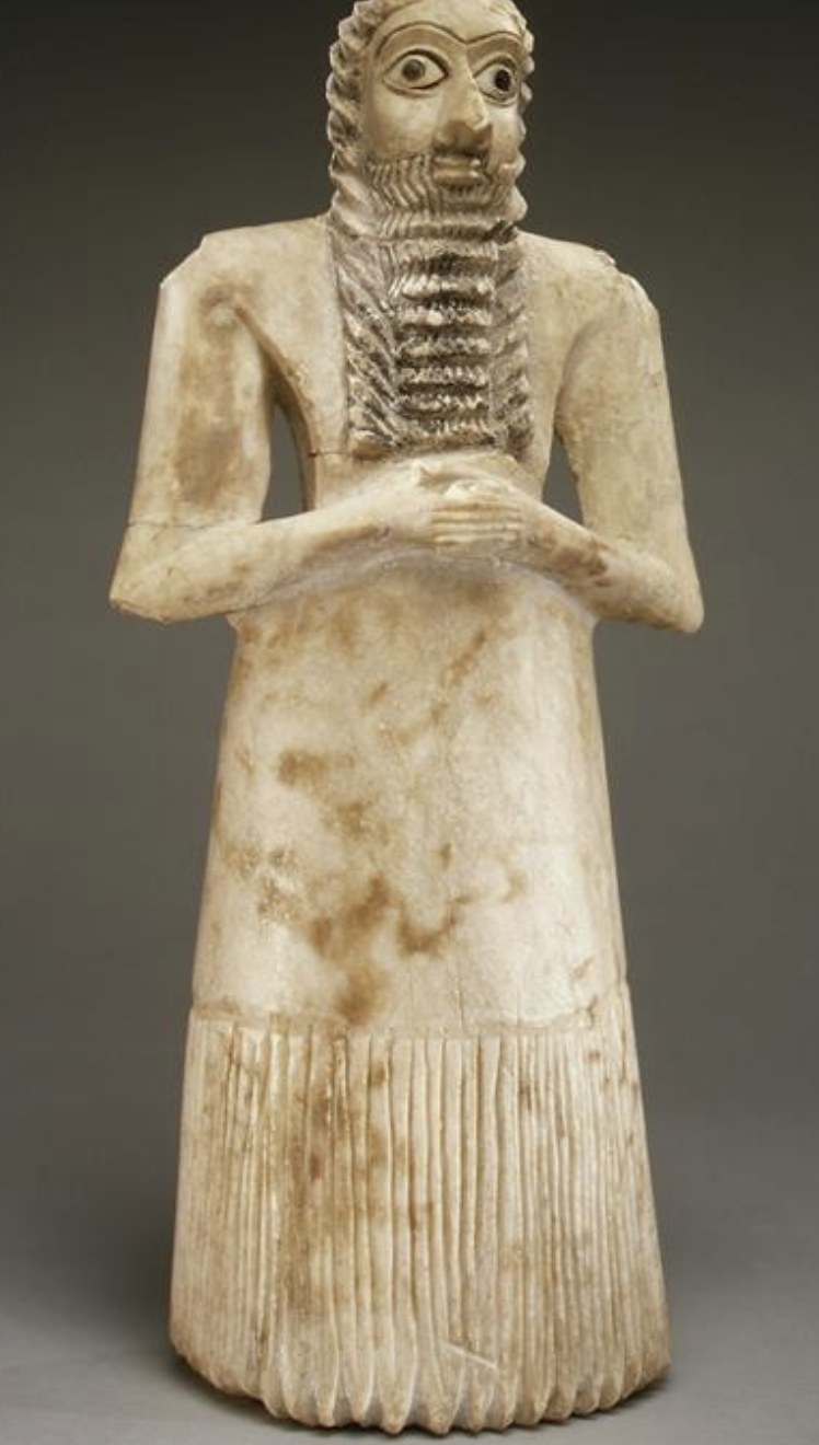 <p>(votive figure), 2800 BCE, gypsum alabaster, shell, black limestone, bitumen, 29.5 x 10 cm, Sumerian, from the Square Temple at Eshnunna (modern Tell Asmar, Iraq), The Metropolitan Museum of Art, New York City</p>