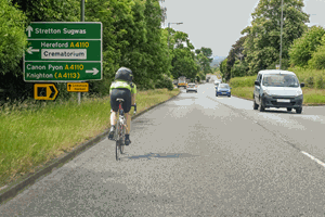 <p>You're following a cyclist. What should you do when you wish to turn left a short distance ahead?</p>