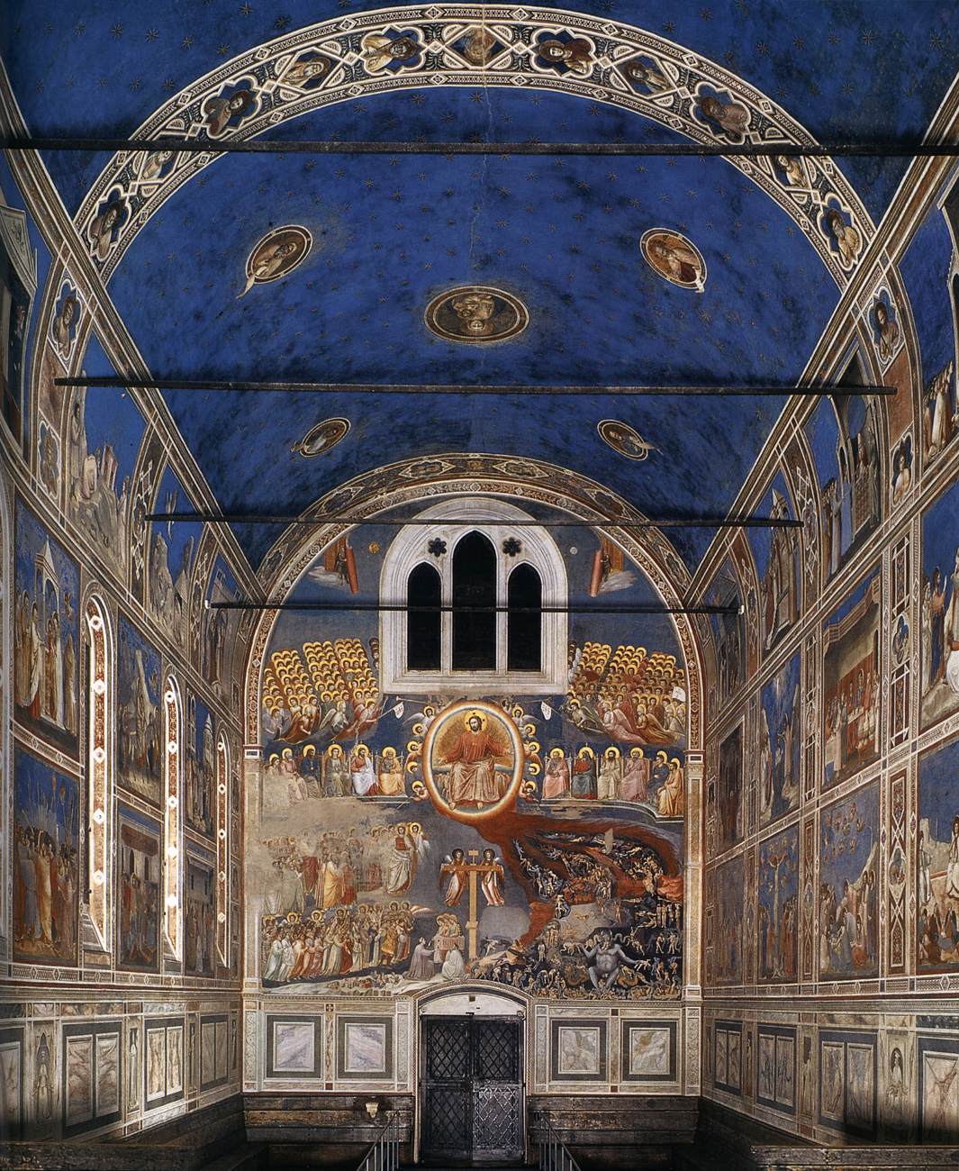 <ul><li><p>Fresco cycle that completely covers the interior of the namesake Arena Chapel in Padua</p></li><li><p>Fresco cycle which depicts the life of Jesus, his parents, his grandparents and the Last Judgement in a contemporary sense</p><ul><li><p>Jesus moves left to right in every scene, thus the namesake helps tell the story within the fresco cycle</p></li></ul></li><li><p>It changed the whole style of painting, having freed it from icon-like formality into something far more naturalistic and dramatic</p></li><li><p>Known for its crowded scenes where it depicts intensely lifelike figures and animals in bright colors against fragments of architecture and a background of intense blue</p></li><li><p>Fresco cycle which showed solidarity, natural detail, and perspective, representing the turning point in Italian painting </p></li><li><p>Features many Renaissance characteristics including</p><ul><li><p>Depth / Linear Perspective</p></li><li><p>Trompe L’oeil (“fools the eye”)</p><ul><li><p>It appears there is a stone frame for the frescoes, but really the stone frame isn’t stone, it’s part of the painting itself</p></li></ul></li><li><p>Secco Fresco</p><ul><li><p>Thus, much of the Lapis Lazuli, which was expensive for the commissioner to invest in, could be seen, and thus it was worth it for the commissioner, Enrico Scrovegni, that the namesake painted it this way</p></li><li><p>The wall of the chapel was made of Lapis Lazuli</p></li><li><p>Lapis Lazuli is blue so much of the blue of the wall can be seen bleeding through the works throughout the chapel</p></li></ul></li></ul></li><li><p>Commissioned by the namesake family</p><ul><li><p>It is located in the Arena Chapel, it was next to the namesake family’s palace</p></li><li><p>It is called the Arena Chapel because it is next to an Ancient Roman Arena</p></li></ul></li></ul><p></p>