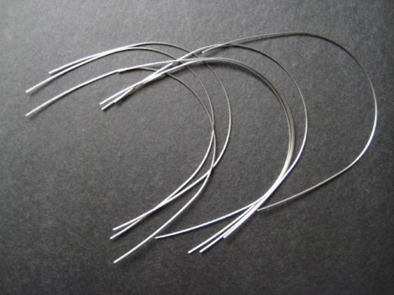<ul><li><p>to place into slots of each bracket and secure with a wire or elastomeric ligature tie on every bracket</p></li><li><p>to move teeth with the force of the arch wire</p></li></ul><p></p>