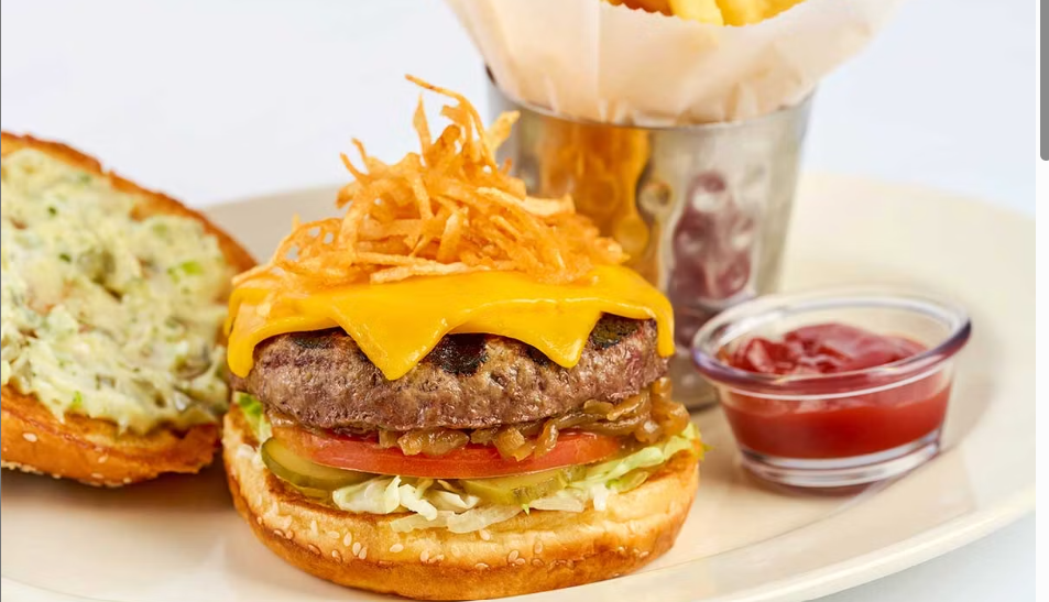 <p>Topped with American and Cheddar Cheese, Crunchy Potato Crisps, Lettuce, Tomato, Grilled Onions, Pickles and Secret Sauce</p>