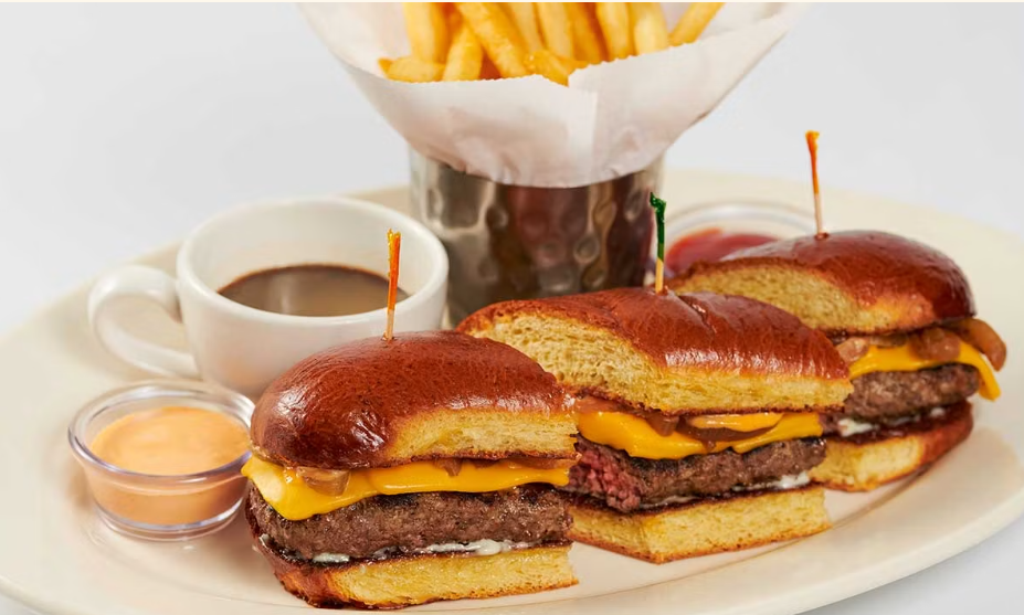 <p>Charbroiled Cheeseburger Served on a Toasted Brioche Roll with Grilled Onions, Sriracha Mayo and Au Jus for Dipping</p>