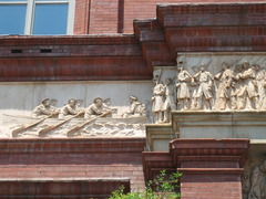 <p>a continuous band of painted or sculptured decoration.</p>