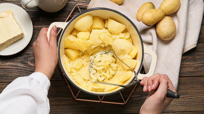 <p>mash</p><p>( Can you mash the potatoes? )</p>