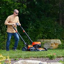 <p>The man is mowing the lawn.</p>