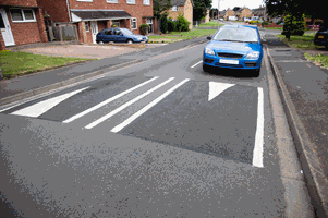 <p>You're driving in a built-up area that has traffic-calming measures. What should you do when you approach a road hump?</p>