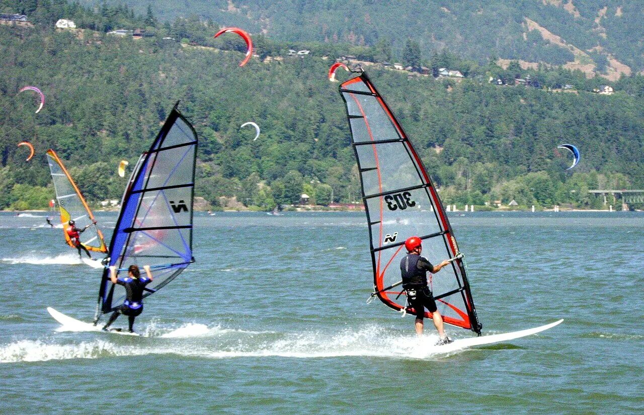 <p>Surfing with a sail attached to the board.</p>