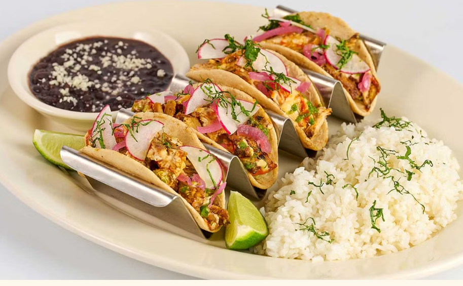 <p>Soft Corn Tortillas Filled with Mildly Spicy Chicken, Cheese, Onion, Chipotle and Cilantro. Served with Rice and Beans</p>