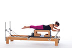 <p><strong>Setup</strong></p><ul><li><p>Lying prone on Long Box, neutral spine position, legs straight and together, parallel to floor, feet plantarflexed, arms bent, elbows facing outward, hands on footbar</p></li><li><p>Resistance: light | <strong>Springs:&nbsp; 1R</strong></p></li></ul><p><strong>Movement</strong></p><ul><li><p>Inhale: Straighten arms</p></li><li><p>Exhale: Bend arms, return to start position</p></li></ul><p><strong>Muscle Focus</strong></p><ul><li><p>Spinal extensors</p></li><li><p>Hip extensors</p></li><li><p>Elbow extensors</p></li><li><p>Spinal flexors</p></li></ul><p><strong>Objectives</strong></p><ul><li><p>Spinal extensor control</p></li><li><p>Hip extensor control</p></li><li><p>Elbow extensor control</p></li><li><p>Scapular stabilization</p></li></ul><p><strong>Cues</strong></p><ul><li><p>Maintain abdominal engagement</p></li><li><p>Maintain back and hip extensor engagement</p></li><li><p>Keep wrists firm and fingers wrapped around footbar</p></li><li><p>Face elbows outward as if arms are on flat surface</p></li></ul><p></p>