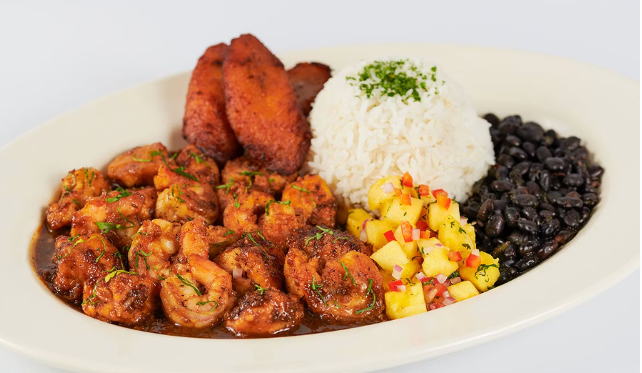<p>Sauteed Chicken and Shrimp with a Very Spicy Jamaican Black Pepper Sauce. Served with Rice, Black Beans, Plantains and Marinated Pineapple</p>