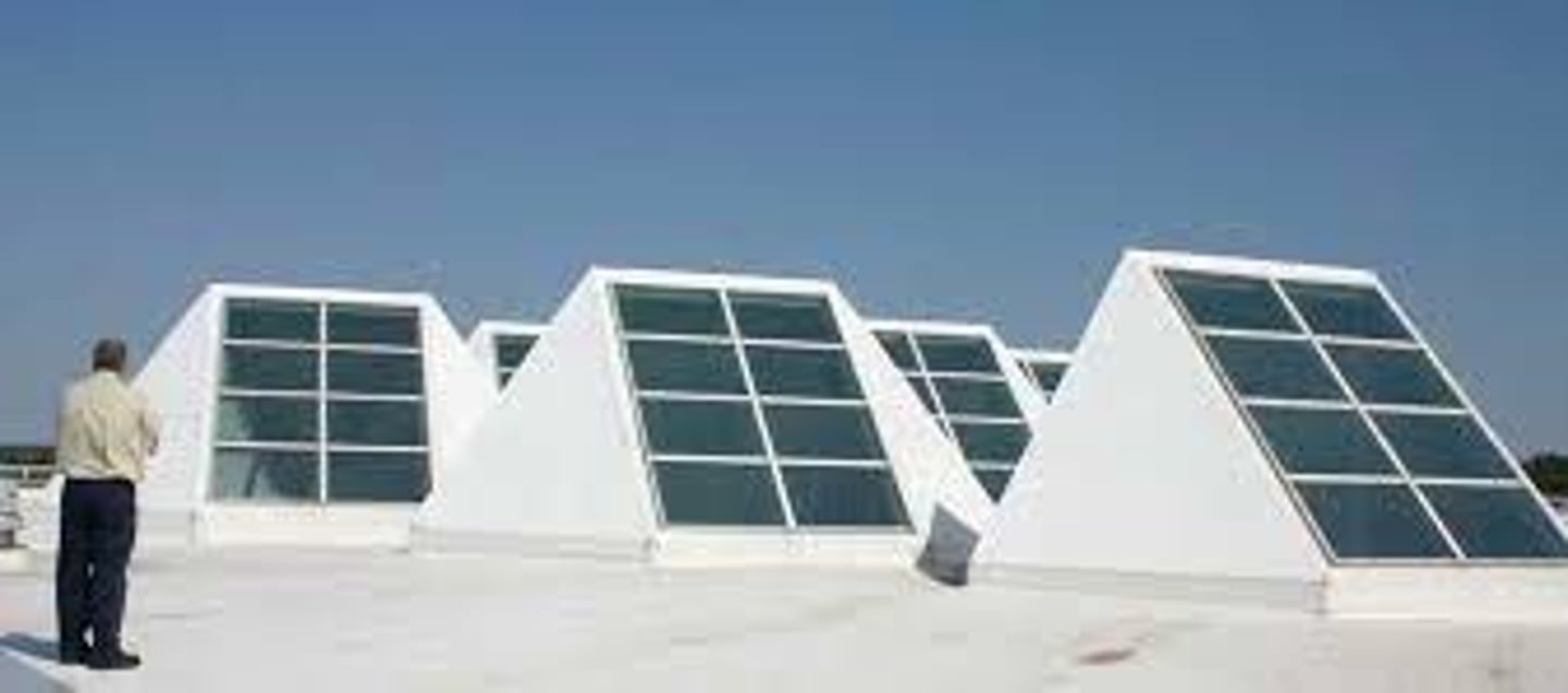 <p>south-facing skylight, that uses tilted panels of transparent glass to strategically bring daylight into an interior space.</p>