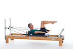<p><strong>Setup</strong></p><ul><li><p>Lying supine in neutral spine position, legs in tabletop position, arms straight and perpendicular to floor, hands in straps, palms facing forward</p></li><li><p>Resistance: light to medium | <strong>Springs: 1R (or 1R+1B)</strong></p></li></ul><p><strong>Movement</strong></p><ul><li><p>Exhale: Lift head and chest, reach arms down to sides of body, parallel to floor</p></li><li><p>Inhale: Lift arms to 90 degrees in the shoulder joint, lower chest and head, return to start position</p></li></ul><p><strong>Muscle Focus</strong></p><ul><li><p>Spinal Flexors</p></li><li><p>Hip flexors</p></li><li><p>Shoulder extensors</p></li></ul><p><strong>Objectives</strong></p><ul><li><p>Spinal flexor strength</p></li><li><p>Hip flexor control</p></li><li><p>Shoulder extensor control</p></li></ul><p><strong>Cues</strong></p><ul><li><p>Move head together with upper girdle</p></li><li><p>Maintain straight arms aligned with shoulders</p></li><li><p>Keep eye line directly forward when in trunk flexion</p></li><li><p>Keep tension in straps throughout movement</p></li></ul><p></p>