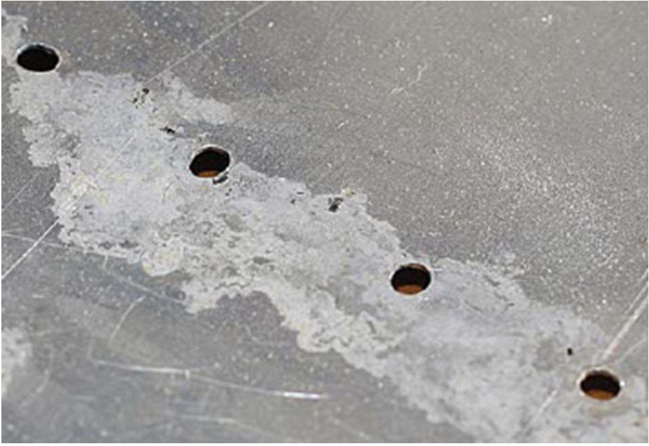 <p>White-to-grey powdery deposits (aluminium oxide/hydroxide). Removed by mechanical polishing or abrasive brushing.</p>