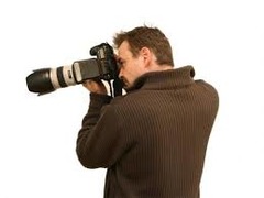 <p>a person who takes photos</p>
