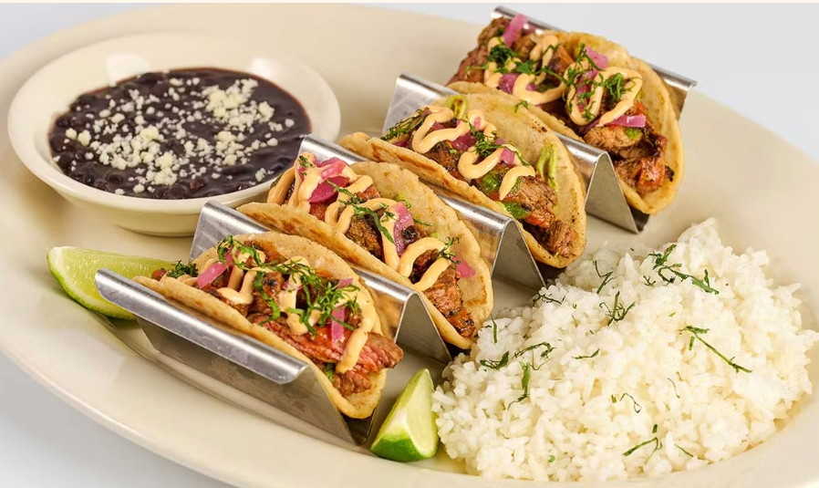 <p>Soft Corn Tortillas, Chargrilled Steak, Avocado Crema, Chipotle Sauce, Onions and Cilantro. Served with Rice and Beans</p>
