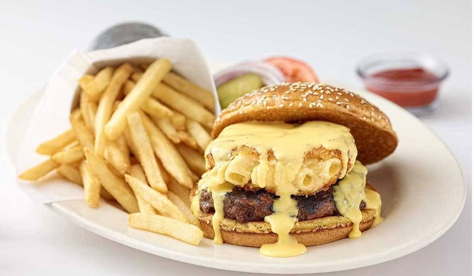 <p>Charbroiled and Topped with Our Creamy Fried Macaroni and Cheese Balls and Cheddar Cheese Sauce. Topped with Lettuce, Tomato, Pickles and Onion</p>