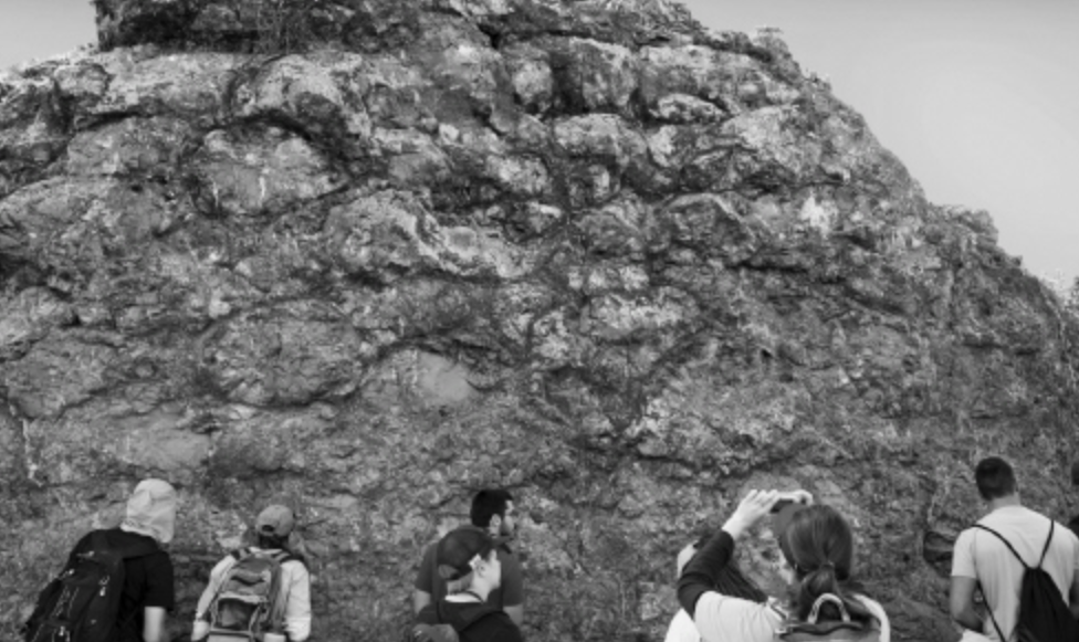 <p><span>The pillow basalts in the photo most likely formed ____________.</span></p>