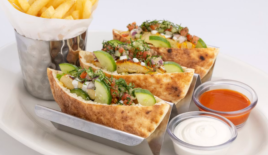 <p>Pita Bread Filled with Grilled Chicken, Tomato, Housemade Pickles, Onion, Garlic and Cilantro.</p>