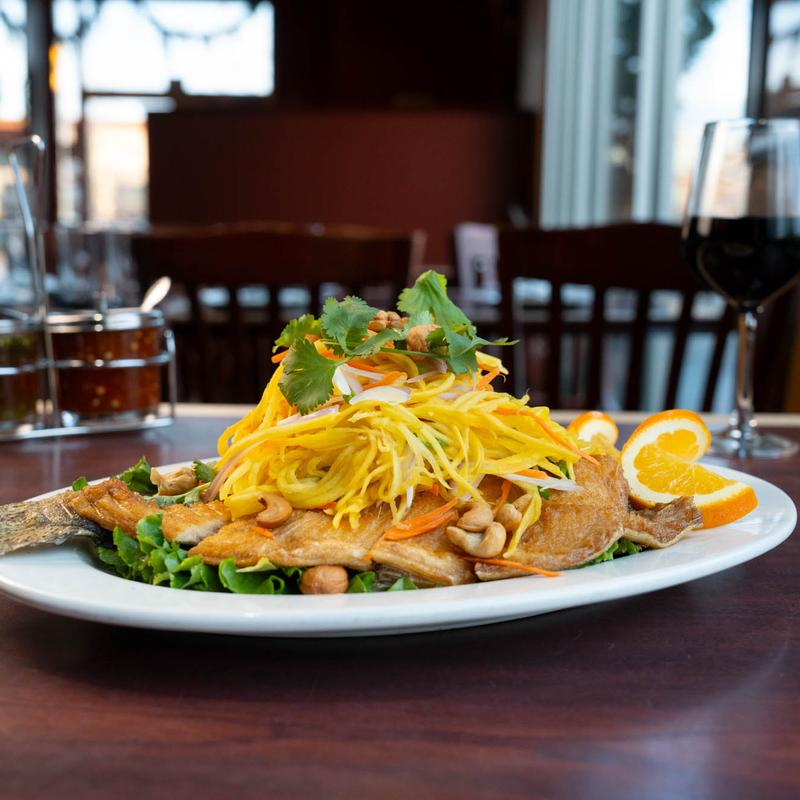 <p>Specialty, fried trout + mango salad on top (mango, carrot, cashews)</p>