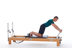 <p><strong>Setup</strong></p><ul><li><p>Kneeling on carriage with sit bones toward heels, feet against shoulder rests, arms straight, shoulder width apart, hands placed on footbar, lift trunk in neutral spine position</p></li><li><p>Resistance: light to medium | <strong>Springs:&nbsp; 1R (or 1R+1B)</strong></p></li></ul><p><strong>Movement</strong></p><ul><li><p>Inhale: Move legs back</p></li><li><p>Exhale: Move legs forward, return to start position</p></li></ul><p><strong>Muscle Focus</strong></p><ul><li><p>Spinal flexors</p></li><li><p>Spinal extensors</p></li></ul><p><strong>Objectives</strong></p><ul><li><p>Pelvic lumbar stabilization</p></li><li><p>Scapular stabilization</p></li><li><p>Knee extensor control</p></li><li><p>Hip extensor control</p></li></ul><p><strong>Cues</strong></p><ul><li><p>Empasize "in" phase of movement</p></li><li><p>Focus on hip disassociation</p></li><li><p>Maintain pelvic lumbar stabilization</p></li><li><p>Maintain neutral spine position</p></li><li><p>Maintain scapular stabilization</p></li></ul><p></p>