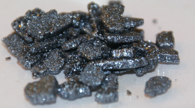 <p>shiny grey-black crystalline solid that sublimes into a purple vapour</p>